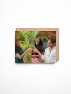 Greeting card with a printed image of two people toasting on a colorful background